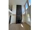 Spacious living room featuring a black marble fireplace extending to the ceiling and lots of natural light at 2455 Bleckley Pl, Cumming, GA 30041