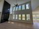 Bright living room featuring hardwood floors, high ceilings, large windows, and a fireplace at 2455 Bleckley Pl, Cumming, GA 30041
