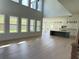 Spacious living room with hardwood floors, large windows, and an open-concept design at 2455 Bleckley Pl, Cumming, GA 30041