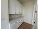 Well-lit butler's pantry with white cabinets, quartz counters, and wood floors at 2455 Bleckley Pl, Cumming, GA 30041