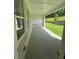 Covered porch with brick base and view of fenced yard and sloping land at 2455 Bleckley Pl, Cumming, GA 30041
