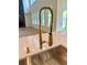 Close-up of the stainless steel sink and stylish gold faucet fixture at 2455 Bleckley Pl, Cumming, GA 30041