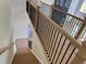 Bright staircase with oak steps, white risers, and a sleek black iron railing at 2455 Bleckley Pl, Cumming, GA 30041