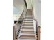 Elegant staircase with oak steps, white risers, and a sleek black iron railing at 2455 Bleckley Pl, Cumming, GA 30041