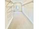 Bright, carpeted walk-in closet featuring adjustable metal shelving for optimal storage at 2455 Bleckley Pl, Cumming, GA 30041