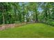 Lush, green backyard enclosed by a wooden fence and lined with mature trees at 2780 Northwood Court Sw Ct, Marietta, GA 30060