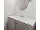 Bathroom featuring a stylish vanity, round mirror, and modern finishes at 2780 Northwood Court Sw Ct, Marietta, GA 30060