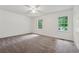 Bright bedroom with neutral carpet, ceiling fan, and view of the outdoors from the double windows at 2780 Northwood Court Sw Ct, Marietta, GA 30060