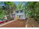 Charming two-story home with a light gray exterior, blue shutters, and a yellow front door at 2780 Northwood Court Sw Ct, Marietta, GA 30060