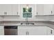 Bright kitchen area with modern appliances, granite countertops, and ample cabinet space at 2780 Northwood Court Sw Ct, Marietta, GA 30060