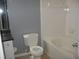 Bathroom with white tub and toilet at 10 Perimeter Summit Ne Blvd # 3105, Atlanta, GA 30319
