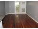 Spacious living room with hardwood floors, a balcony, and neutral paint at 10 Perimeter Summit Ne Blvd # 3105, Atlanta, GA 30319