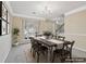Dining room with a large window, neutral wall color, carpeted floors, and a chandelier light at 1056 Shadow Lake Dr, Lithonia, GA 30058