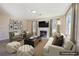 Staged living room with a fireplace, neutral tones, and plenty of natural light, perfect for relaxing and entertaining at 1056 Shadow Lake Dr, Lithonia, GA 30058