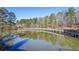 Scenic pond featuring a gazebo and wooden walkway, reflecting the lush trees in the calm water at 1056 Shadow Lake Dr, Lithonia, GA 30058