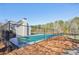 Community pool featuring a fenced-in area with beautiful landscaping and mature trees at 1056 Shadow Lake Dr, Lithonia, GA 30058