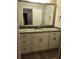 Modern bathroom with granite vanity top, framed mirror and wood-look flooring at 1547 Grove Arbor Ter, Dacula, GA 30019