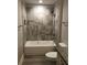 Bright bathroom features tile-surround shower, granite countertop and white cabinetry at 1547 Grove Arbor Ter, Dacula, GA 30019
