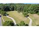 Aerial shot of the park with walking paths and soccer fields surrounded by mature trees at 1547 Grove Arbor Ter, Dacula, GA 30019