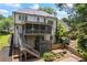 Spacious home exterior with a two-story deck overlooking the landscaped backyard at 1547 Grove Arbor Ter, Dacula, GA 30019