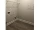 Functional laundry room space with vinyl floors, utility shelf and laundry hookups at 1547 Grove Arbor Ter, Dacula, GA 30019