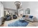 Open concept living room with large windows, hardwood floors, and modern decor at 1547 Grove Arbor Ter, Dacula, GA 30019