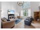 Elegant living room with fireplace, hardwood floors, and bright windows at 1547 Grove Arbor Ter, Dacula, GA 30019