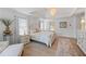 This bedroom includes a decorative light fixture, and neutral colored walls and floors at 1547 Grove Arbor Ter, Dacula, GA 30019