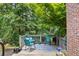 Back patio with furniture and view of lush trees at 1547 Grove Arbor Ter, Dacula, GA 30519