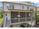 Exterior of back porch with seating area and stairs leading to the backyard at 1547 Grove Arbor Ter, Dacula, GA 30519