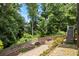 Backyard with wood fence, stone walkway, and stairs to upper decks at 1547 Grove Arbor Ter, Dacula, GA 30519