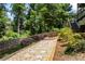 Landscaped backyard features wood fence and a stone pathway at 1547 Grove Arbor Ter, Dacula, GA 30519