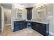 Bathroom featuring double granite-topped vanities with dark cabinets and tiled floors at 1547 Grove Arbor Ter, Dacula, GA 30519