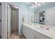 Bathroom featuring double sinks, large mirror, and shower with curtain at 1547 Grove Arbor Ter, Dacula, GA 30519