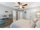Bedroom with a ceiling fan and a dresser with white accents and ensuite bathroom at 1547 Grove Arbor Ter, Dacula, GA 30519