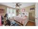 A cozy bedroom with a exercise equipment, ceiling fan, and lots of natural light at 1547 Grove Arbor Ter, Dacula, GA 30519