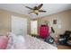 Bedroom with a ceiling fan, exercise equipment, and bright pink dresser at 1547 Grove Arbor Ter, Dacula, GA 30519