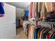 Walk-in closet featuring ample hanging space and shelving for organized storage of clothing and shoes at 1547 Grove Arbor Ter, Dacula, GA 30519