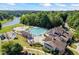 Aerial view of a well-maintained community pool, playground, and surrounding green spaces at 1547 Grove Arbor Ter, Dacula, GA 30519