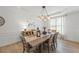 Beautiful dining space with natural light and a modern chandelier at 1547 Grove Arbor Ter, Dacula, GA 30519