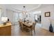 Bright dining room with modern lighting, hardwood floors, and elegant decor at 1547 Grove Arbor Ter, Dacula, GA 30519