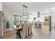 Bright dining room with modern light fixture, hardwood floors and direct access to the kitchen at 1547 Grove Arbor Ter, Dacula, GA 30519