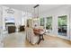 Inviting dining room with elegant chandelier, and access to a screened porch and living room at 1547 Grove Arbor Ter, Dacula, GA 30519
