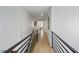 Bright hallway showcasing hardwood floors, modern railing and access to bedrooms at 1547 Grove Arbor Ter, Dacula, GA 30519