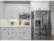 Well-appointed kitchen featuring stainless steel appliances, ample white cabinetry, and a bright countertop at 1547 Grove Arbor Ter, Dacula, GA 30519