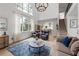 Bright and airy living room with vaulted ceilings, large windows, and modern staircase at 1547 Grove Arbor Ter, Dacula, GA 30519