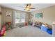 room with bright light from the window and a ceiling fan for comfortable cooling at 1547 Grove Arbor Ter, Dacula, GA 30519