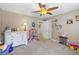 A well-lit room with a ceiling fan and dresser for ample storage and display at 1547 Grove Arbor Ter, Dacula, GA 30519