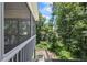 View from the screened porch with stairs to the landscaped backyard with wood fencing at 1547 Grove Arbor Ter, Dacula, GA 30519