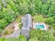 Bird's-eye view of the home featuring a backyard pool, a lush lawn, manicured landscaping, and a tranquil setting at 280 W Knight W Rd, Mcdonough, GA 30252